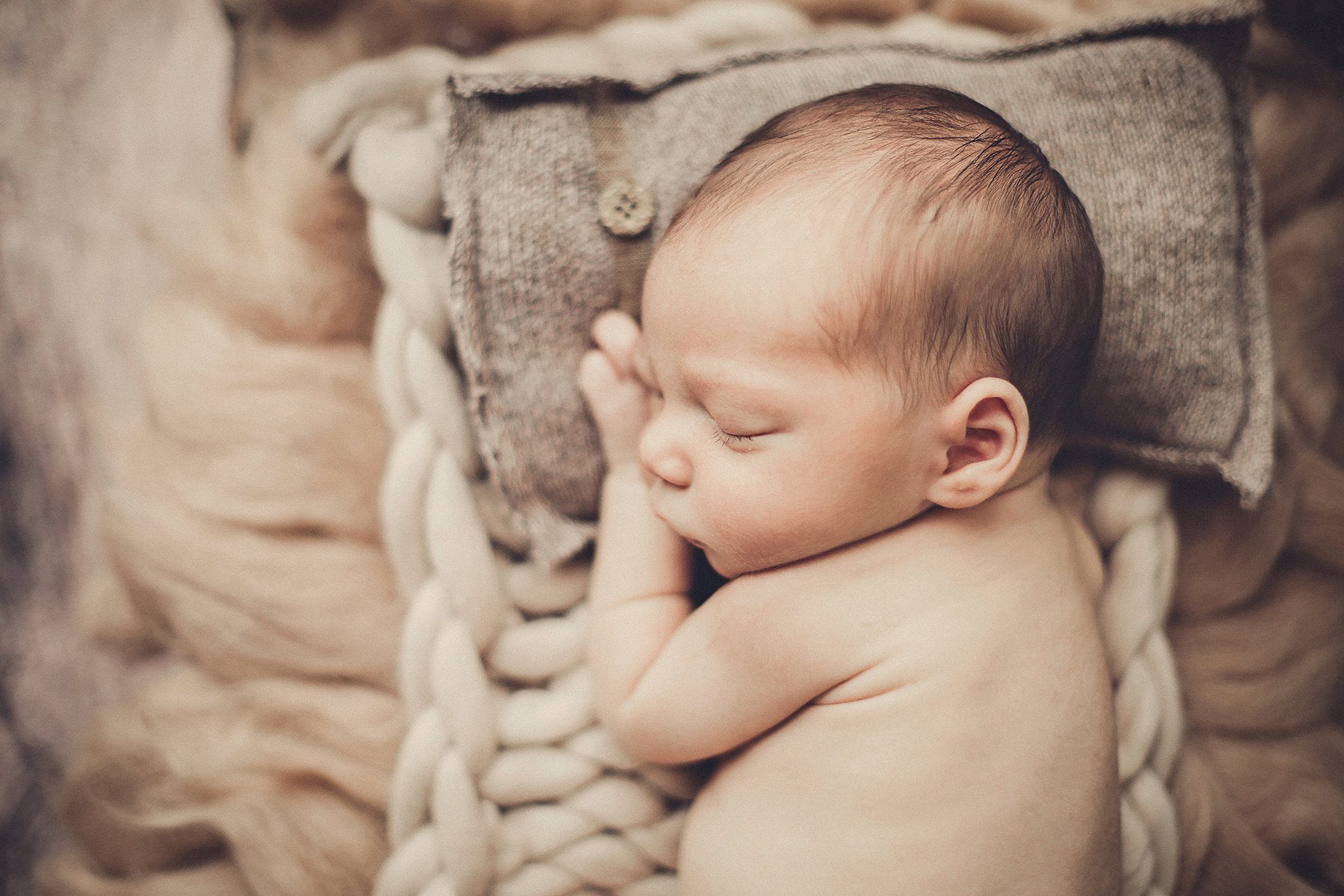 Kansas City Newborn Photographer in bed prop