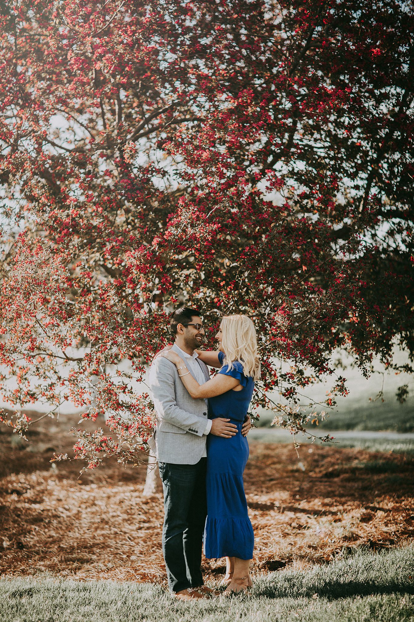 Engagement photographer with spring blossoms